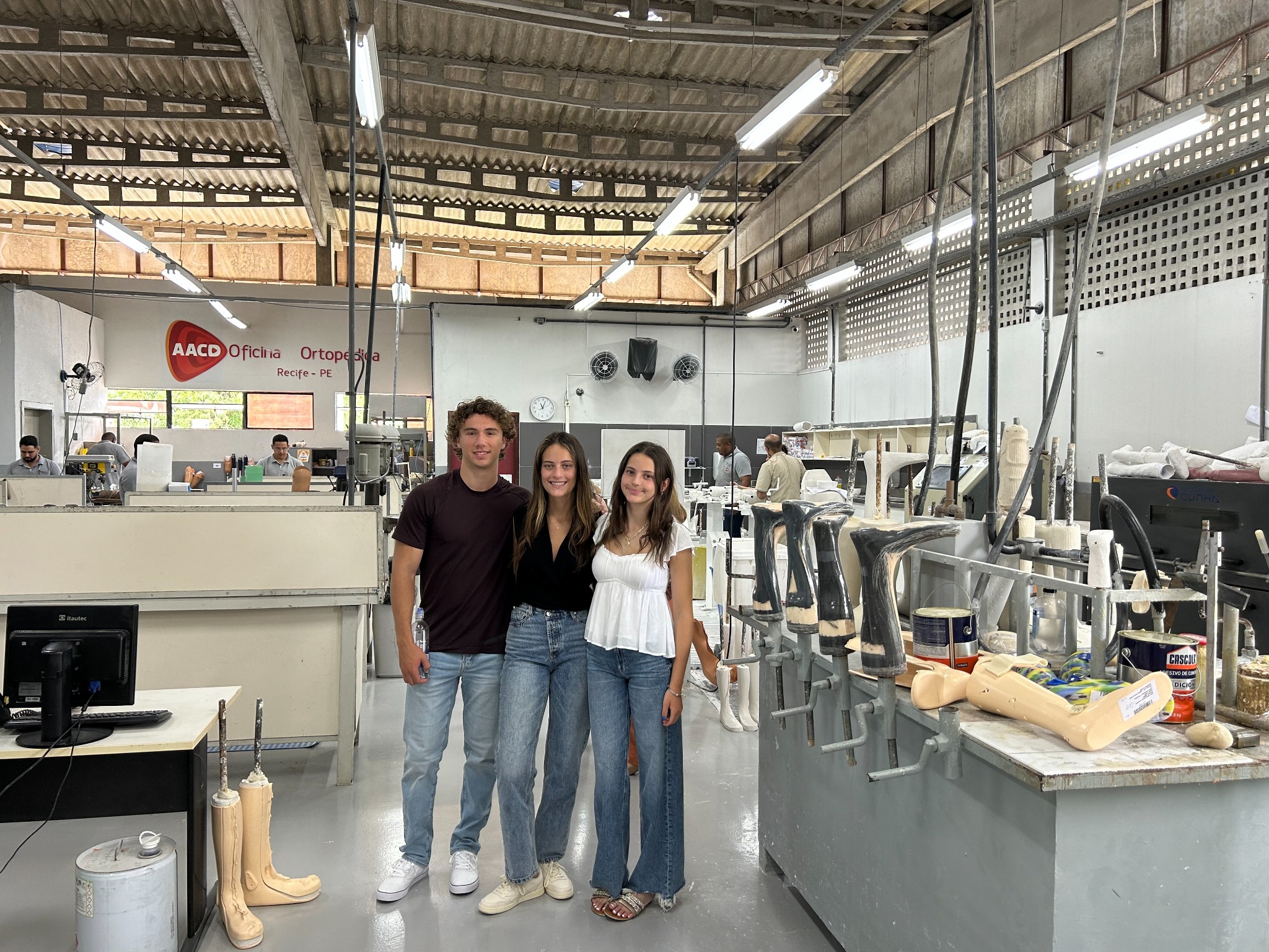 Vivi visiting AACD’s orthopedic workshop with her siblings