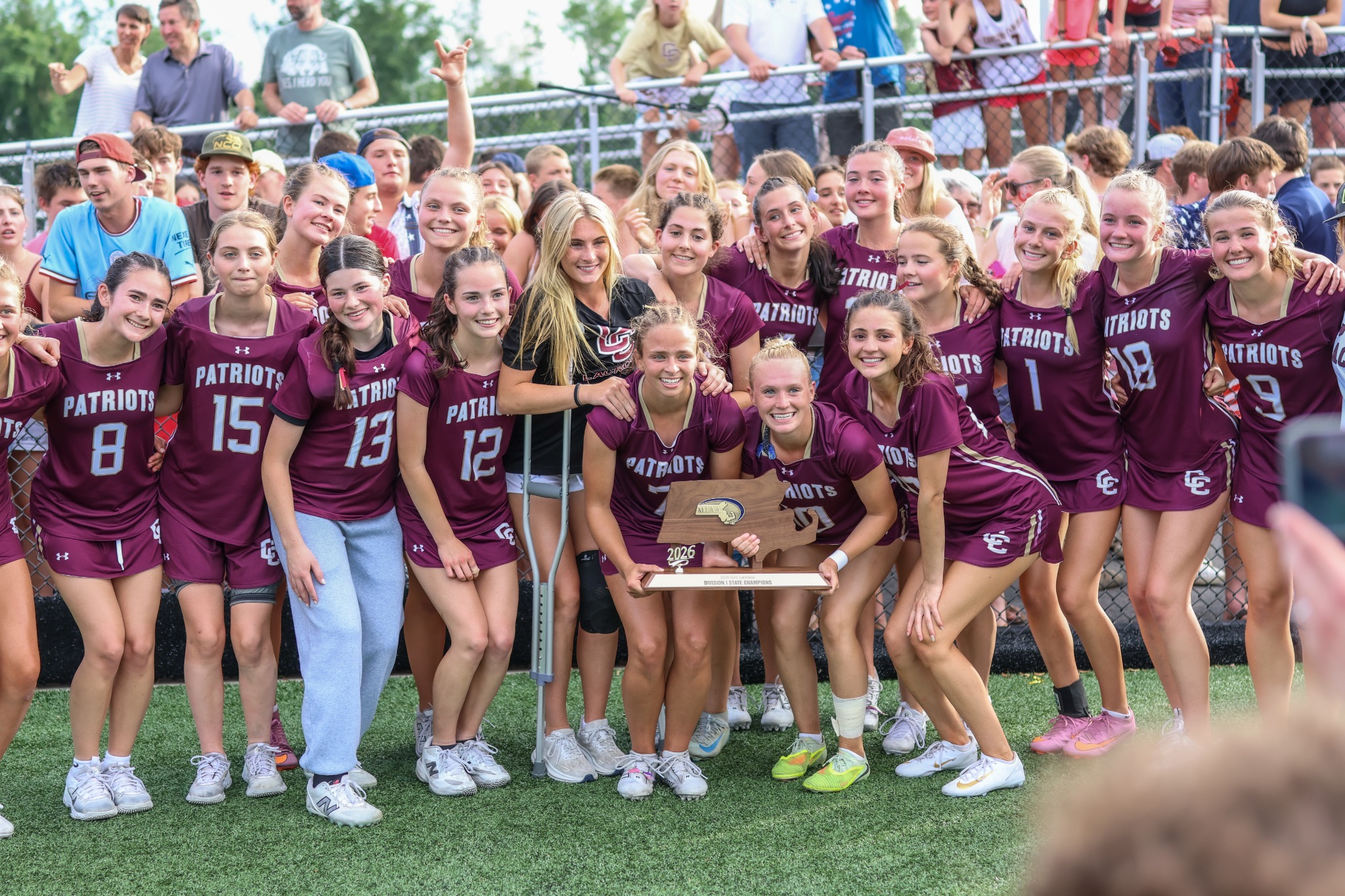 The 2026 Concord-Carlisle state championship lacrosse team with its trophy